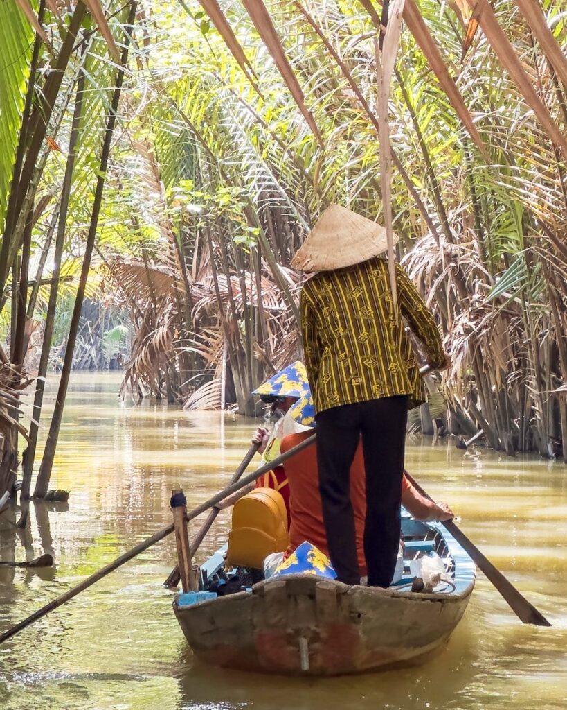 Vietnam travel by sampan on the Mekong River.