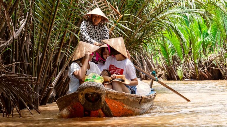 A sampan carrying travelers on a Mekong Delta private tour.