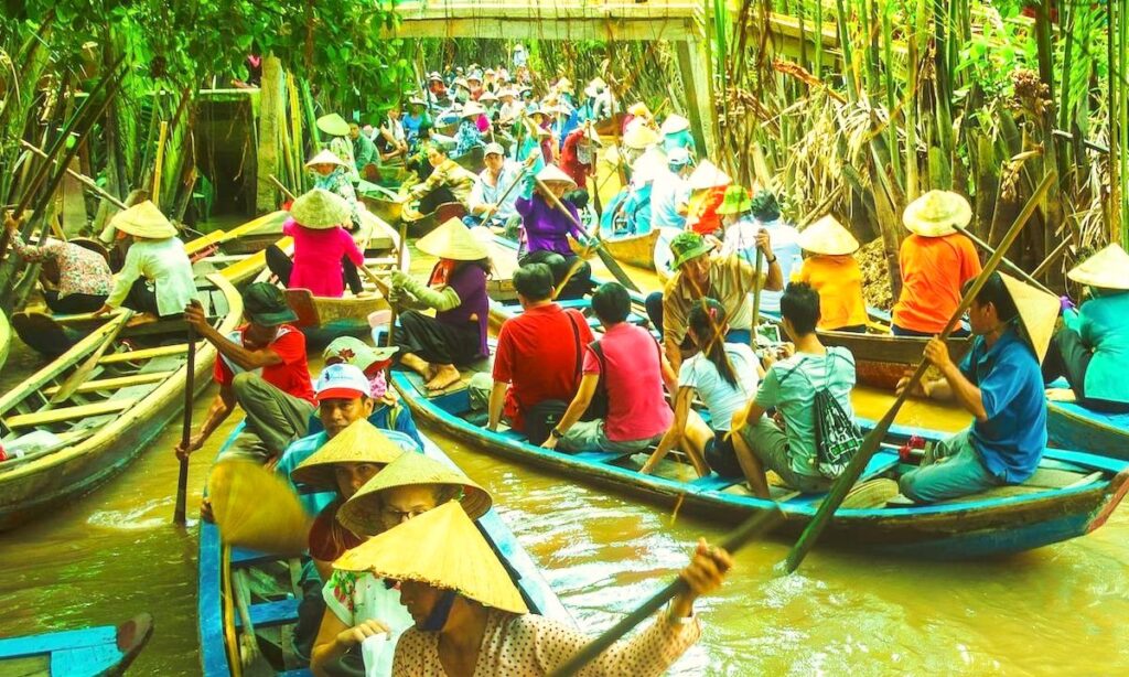 Sampans waiting their turn to pass under a bridge on our 3-Day Mekong River Tour.