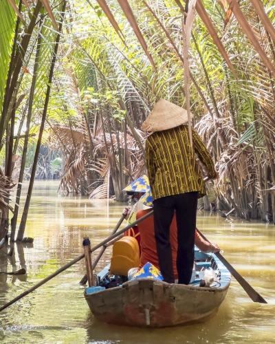 Vietnam travel by sampan on the Mekong River.
