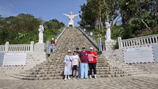 Tour guests climbing the steps to the Jesus Christ statue