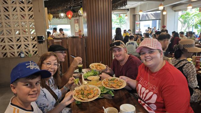 Tour guests eating banh khot in Vung Tau